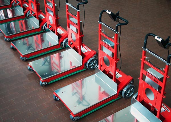 A row of Zonzini electric stair climbing sack trucks