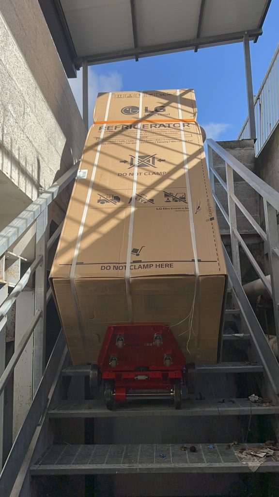 Transporting heavy parcels to an outside hall with the Zonzini Buddy Plasmoid stair trolley